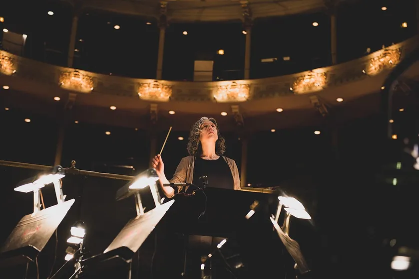 Conductor leading an orchestra
